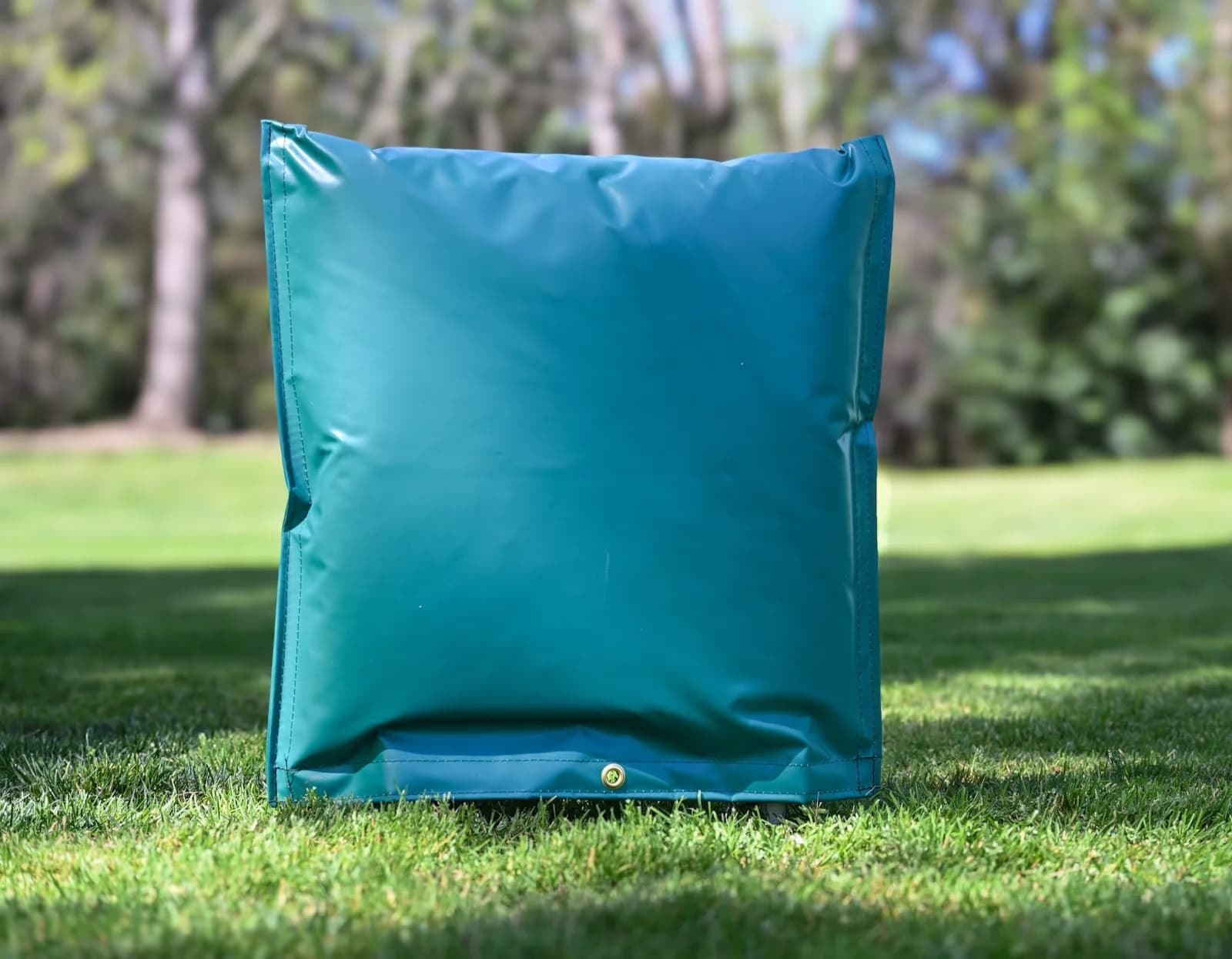 Green 20 by 20 inch closed-top insulated backflow cover standing on grass, with the brass lock grommet visible at the base.